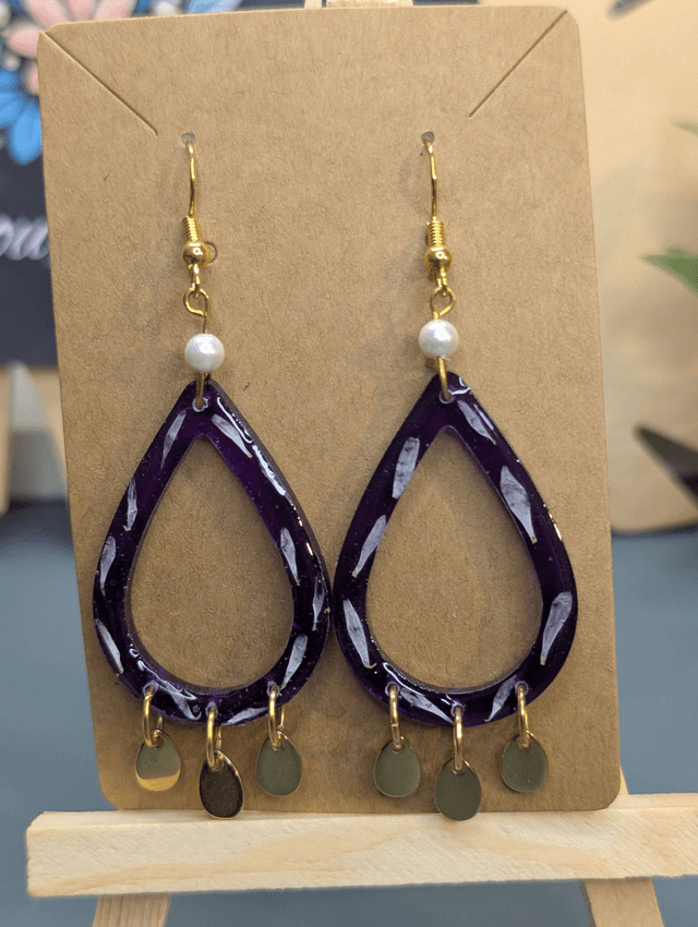Boucles d'oreilles pendante en forme de goutte violette. 