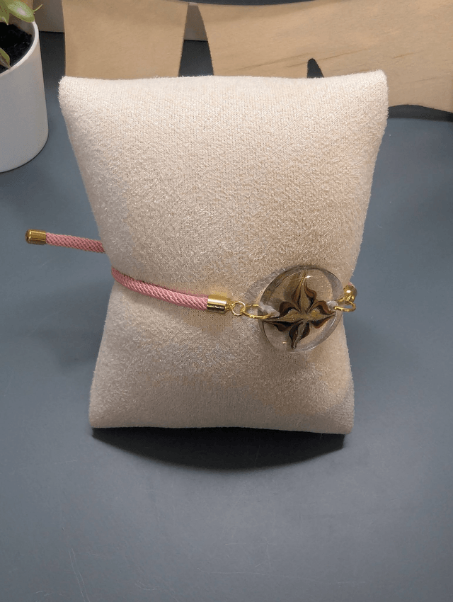 Bracelet corde ajustable rose et pendentif rond en résine.