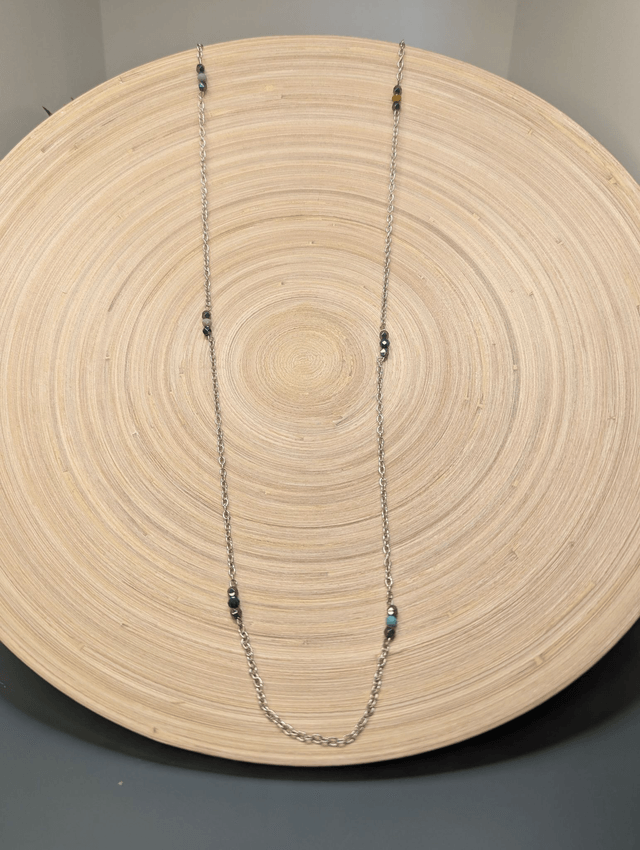 Collier long avec de la chaine couleur argent, intercalé de perles d'hématite noir et de perles colorés en verre. 