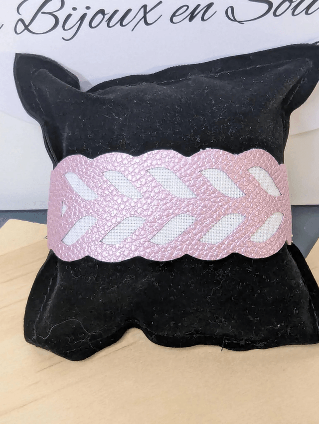 Bracelet manchette en cuir rose poudré, avec du tissus enduit blanc (résistant), une chaine argent. Le fermoir est de couleur argent.