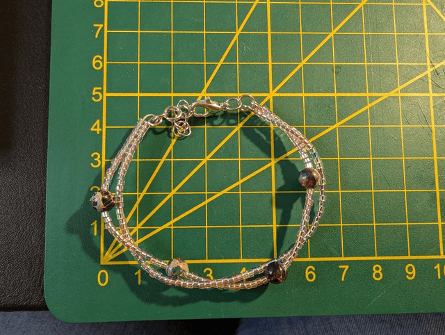 Bracelet torsadé rose, bleu, et violet avec des perles Miyuki en verre, des perles naturelles. Le fermoir est de couleur argenté.