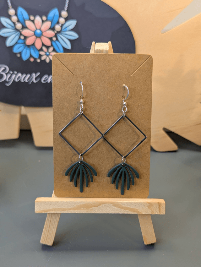 Boucles d'oreilles longue avec pendentif carré et feuille verte.