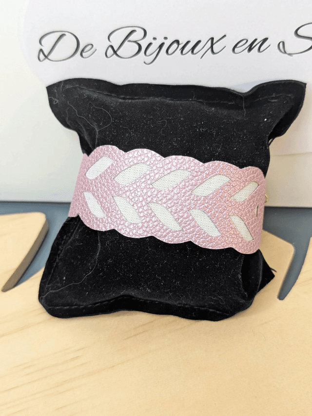 Bracelet manchette en cuir rose poudré, avec du tissus enduit blanc (résistant), une chaine couleur or. Le fermoir est de couleur or.