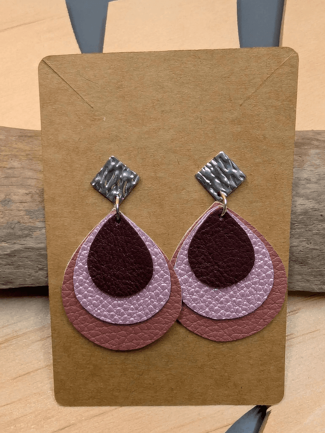 Boucles d&#039;oreilles en cuir en forme de goutte avec un dégradé de rose/violet et le derrière est en blanc. Le fermoir en clou carré est en argent.
